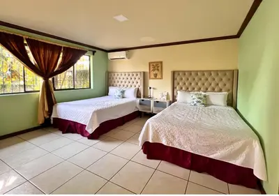a bedroom with two beds and a window at Villa Noelia in El Jurón