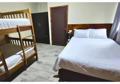 a bedroom with two bunk beds and a doorway at Villa Noelia in El Jurón