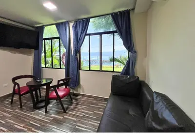 a living room with a couch and a table and a window at Villa Noelia in El Jurón