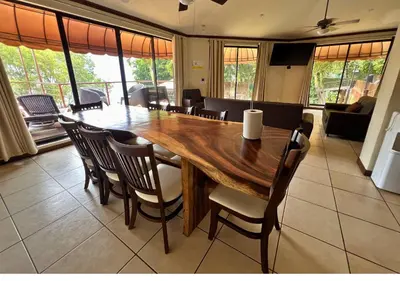 a dining room with a large wooden table and chairs at Villa Noelia in El Jurón