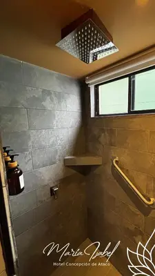a bathroom with a shower with a sink and a shower at Hotel María Isabel Ataco in Concepción de Ataco