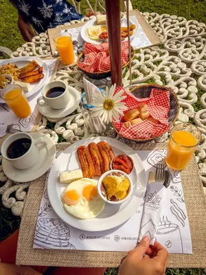 a breakfast table with eggs and other breakfast foods at Hotel María Isabel Ataco in Concepción de Ataco