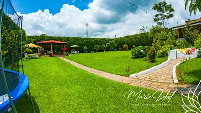 a green yard with a path in the grass at Hotel María Isabel Ataco in Concepción de Ataco