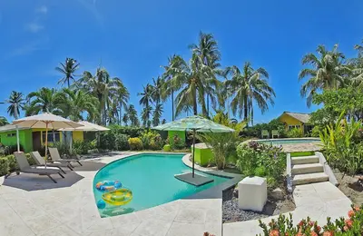 a swimming pool with an umbrella and a house at Casa de Playa Bosque de Mangle en Playa El Espino in El Arco