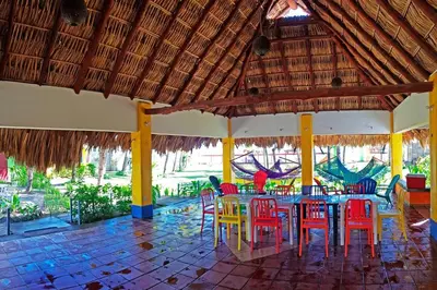 a dining room with a table and colorful chairs at Casa de Playa Bosque de Mangle en Playa El Espino in El Arco