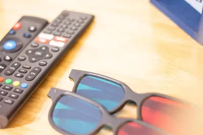 a pair of sunglasses sitting on a table next to a remote control at Habitación Agua - Villa Valle Campo in Nahuizalco