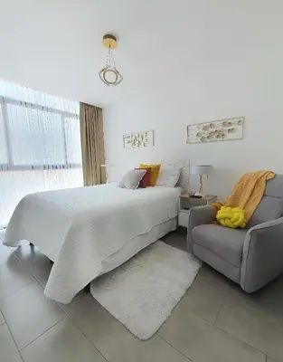 a bedroom with a large bed and a couch at Avitat Joy Cozy&Homy 2B Flat Private Wifi Pool Gym in San Salvador