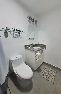 a white bathroom with a toilet and a sink at Avitat Joy Cozy&Homy 2B Flat Private Wifi Pool Gym in San Salvador