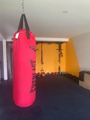 a large red punching bag hanging in a room at Avitat Joy Cozy&Homy 2B Flat Private Wifi Pool Gym in San Salvador