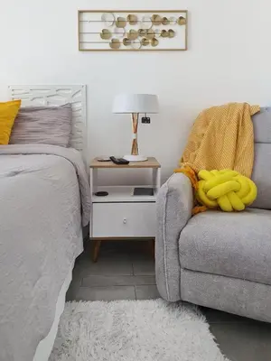 a bedroom with a bed and a couch with bananas on it at Avitat Joy Cozy&Homy 2B Flat Private Wifi Pool Gym in San Salvador
