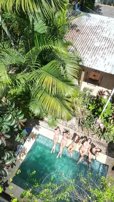 a group of men standing in a swimming pool at Casa Makoi in Tamanique