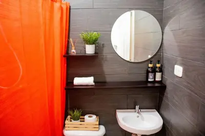 a bathroom with a sink and a mirror at Habitacion Fuego - Villa Valle Campo in Nahuizalco