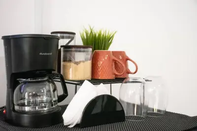 a counter with a coffee maker and other items on it at Habitacion Fuego - Villa Valle Campo in Nahuizalco