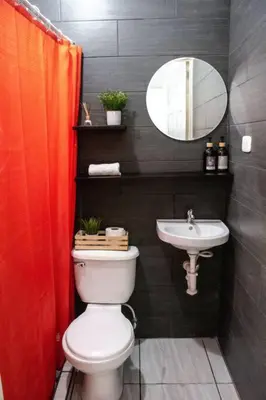 a bathroom with a white toilet and a sink at Habitacion Fuego - Villa Valle Campo in Nahuizalco
