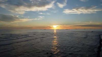 a sunset over the ocean with the sun setting at Quinta Luna Mar, Residencial Las Veraneras in Acajutla