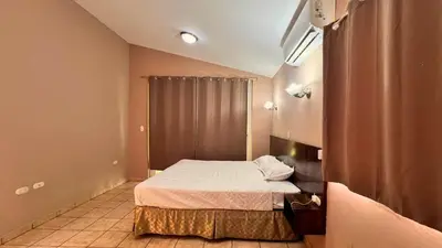 a small bedroom with a bed in a room at Quinta Luna Mar, Residencial Las Veraneras in Acajutla