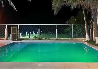 a swimming pool in front of a fence at Quinta del Carmen, Playa San Diego in La Libertad