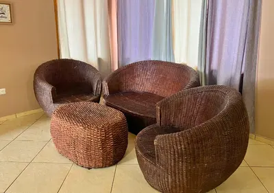 three wicker chairs and a stool in a room at Quinta del Carmen, Playa San Diego in La Libertad