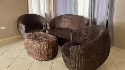 two wicker chairs and a stool in a room at Quinta del Carmen, Playa San Diego in La Libertad