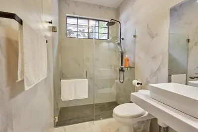 a bathroom with a shower and a toilet and a sink at New in the heart of the city 5 min to US Embassy in Nuevo Cuscatlán
