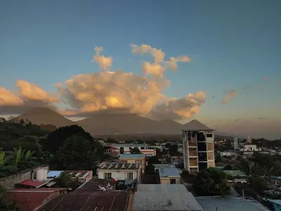 a view of a city with mountains in the background at Samay Hostel in Juayúa