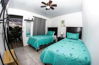 a bedroom with two beds and a ceiling fan at Hostal Jasmin in Berlín