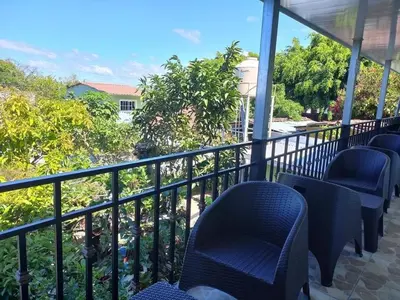 a balcony with blue chairs and a view of trees at Hostal Jasmin in Berlín