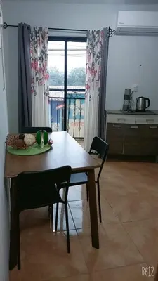 a wooden table and chairs in a kitchen with a window at Hostal Jasmin in Berlín