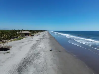 an overhead view of a beach with the ocean at Hotel Paseo del Sol in La Paz