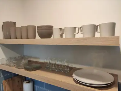a wooden shelf with glasses and cups on it at Acogedor Depto. en el corazón Santa Tecla in Nueva San Salvador