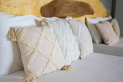 a group of pillows sitting on top of a bed at Tres Piedras in San Francisco Chinameca