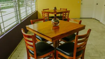 a dining room with a wooden table and chairs at LA RUTA HOTEL CORPORATIVO in San Salvador