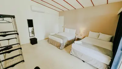 a small room with two beds and a ladder at LA RUTA HOTEL CORPORATIVO in San Salvador