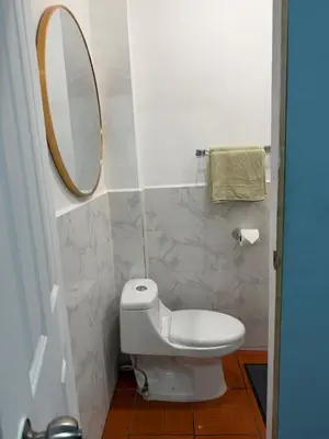 a bathroom with a toilet and a mirror at Hospedaje Mónaco in San Miguel