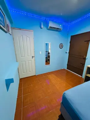 a blue room with a door and a wooden floor at Hospedaje Mónaco in San Miguel