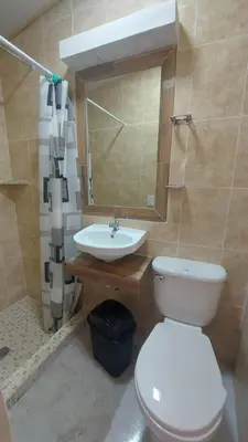 a bathroom with a white toilet and a sink at Alojamientos Santa Marta La Unión in La Unión