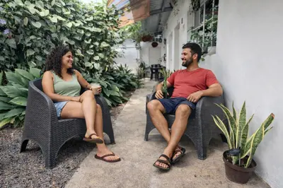 a man and a woman sitting in chairs at Habitación Deluxe Aire - Villa Valle Campo in Nahuizalco