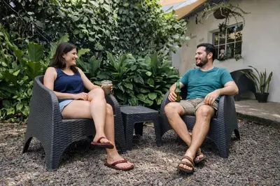 a man and a woman sitting in chairs at Habitación Deluxe Aire - Villa Valle Campo in Nahuizalco