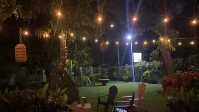 a garden at night with lights and chairs at HOTEL EL VIAJERO in La Libertad