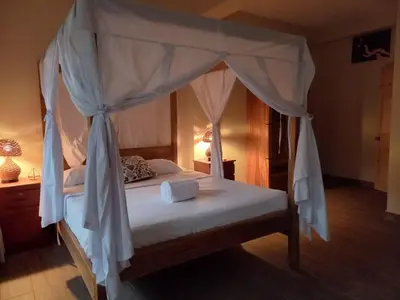 a bedroom with a bed with a canopy at HOTEL EL VIAJERO in La Libertad