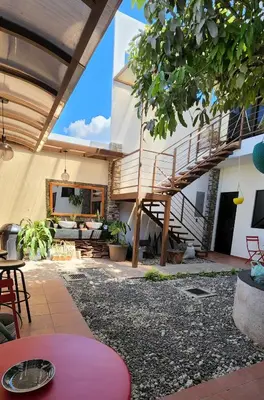 a patio with a staircase in a house at Altea Hostal in Santa Ana