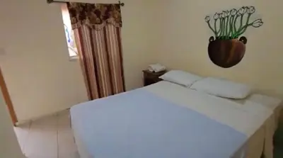 a white bed in a room with a window at Hostal y Restaurante Posada Real in La Palma