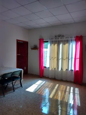 a room with red and yellow curtains and a table at Casa Hotel Familiar in San Lucas