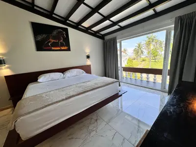 a bedroom with a large bed and a large window at HOTEL TESORO BEACH in San Luis La Herradura
