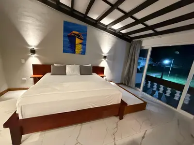 a bedroom with a bed and a large window at HOTEL TESORO BEACH in San Luis La Herradura
