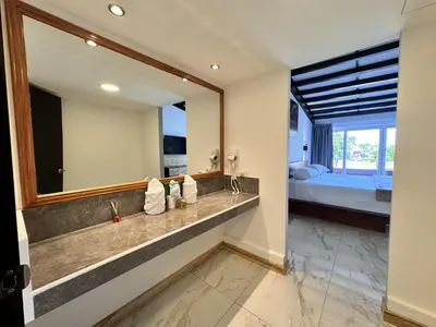 a bathroom with a sink and a large mirror at HOTEL TESORO BEACH in San Luis La Herradura
