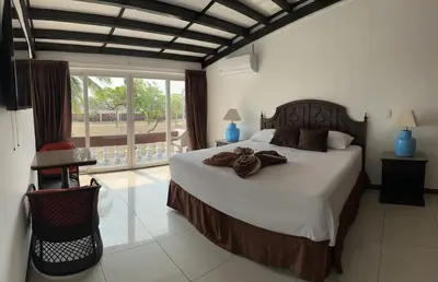 a bedroom with a large bed with towels on it at HOTEL TESORO BEACH in San Luis La Herradura