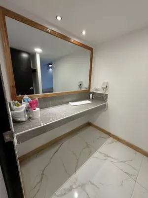 a bathroom with a sink and a large mirror at HOTEL TESORO BEACH in San Luis La Herradura