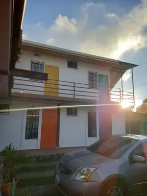 a house with a car parked in front of it at Hostal Puertas De Apaneca in Apaneca
