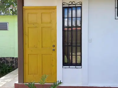 a yellow door on the side of a house at Hostal Puertas De Apaneca in Apaneca